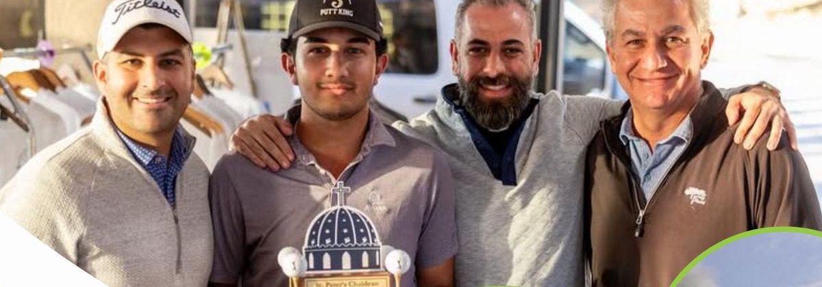 Four golfers holding the St. Peter Cathedral Golf Tournament trophy