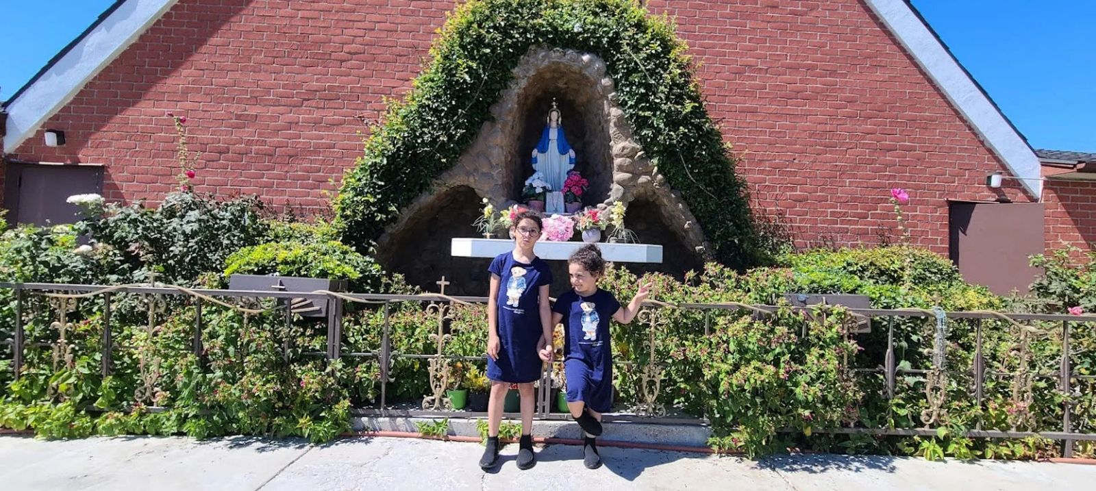 Two children in front of the Marian grotto at St. Paul