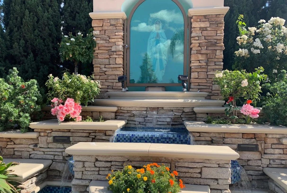 A stone shrine and fountain in the garden of St. Thomas