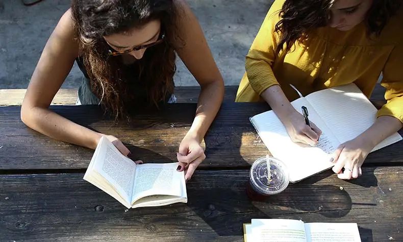 Students reading together at a table