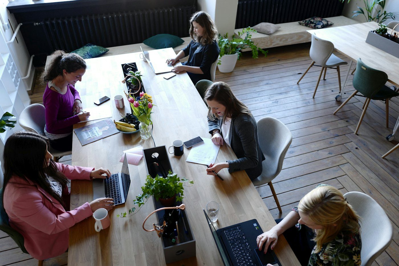 A team working around a table with laptops